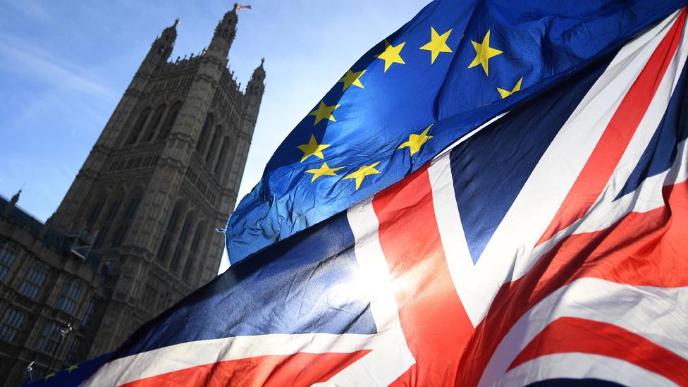 Union Jack and EU flag flying near the Palace of Westminster