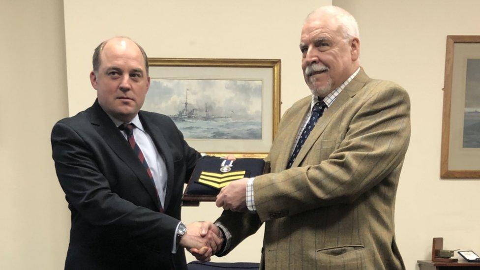 Joe Ousalice being re-awarded a Long Service and Good Conduct Medal and three Good Conduct badges