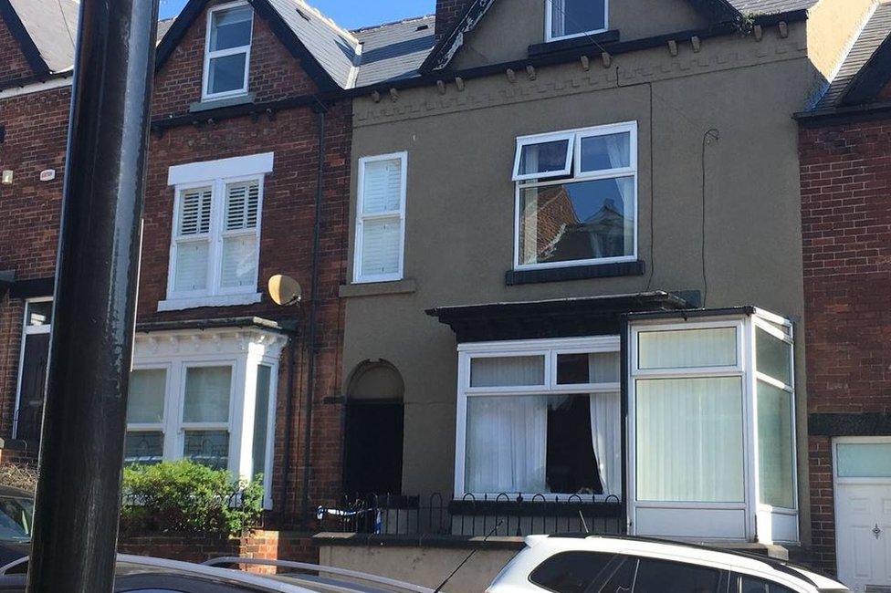 Terraced house with broken downstairs window