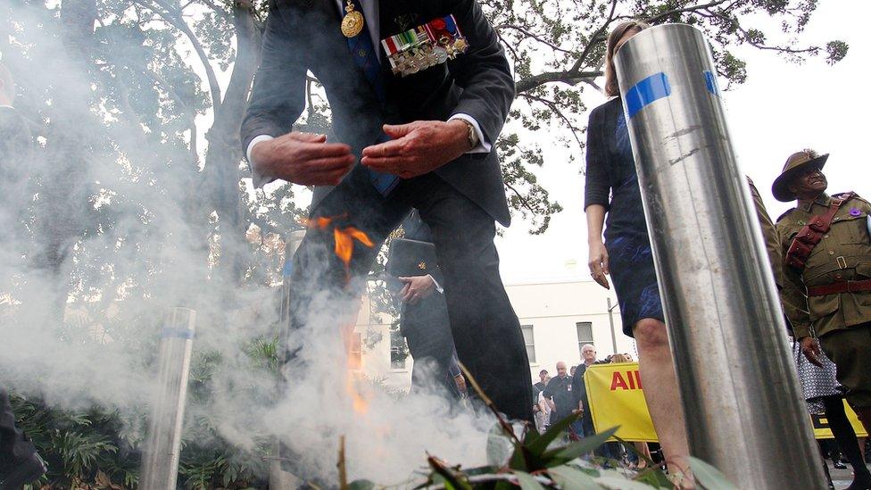 A man partakes in a traditional smoke ceremony at an Anzac Day service in Sydney in 2017