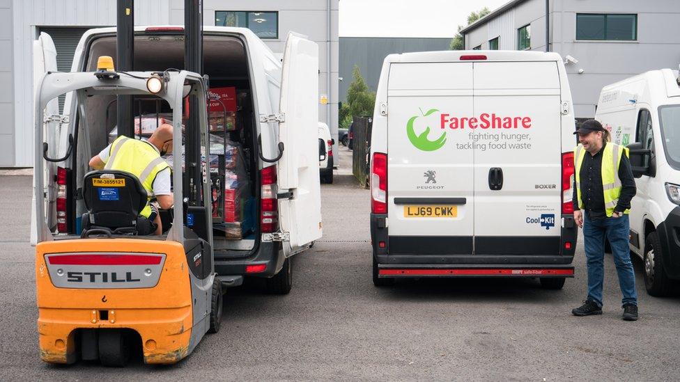 food being loaded into vans