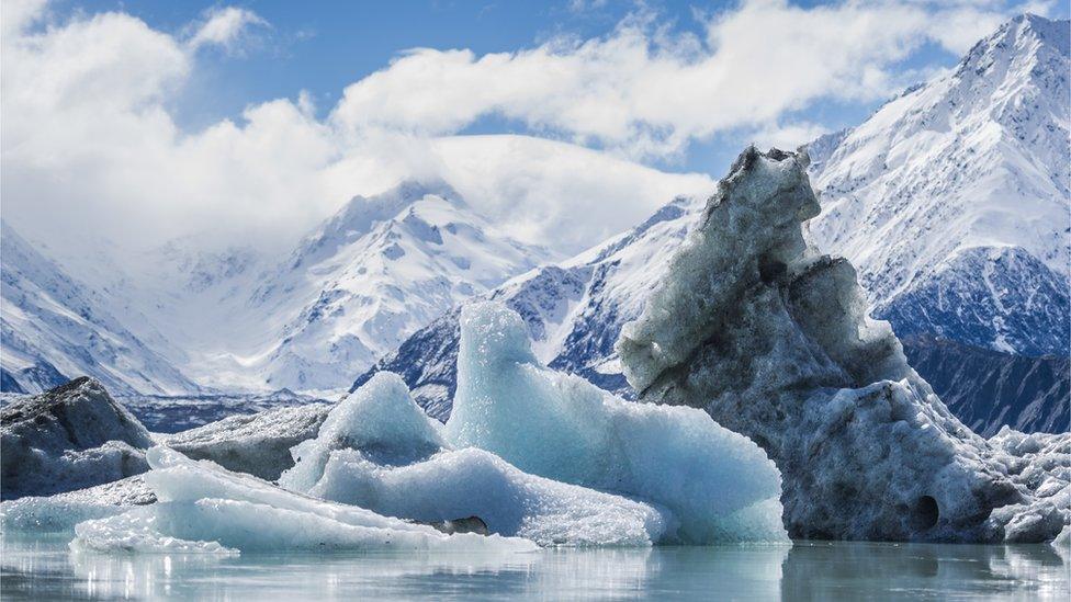 icebergs melting off a glacier