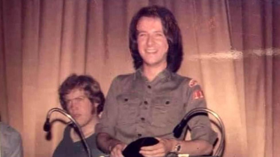 Richard Searling holding a record on stage at Wigan Casino in the 1970s