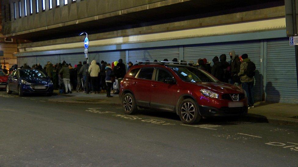 People queue for a hot meal in Grimston Street