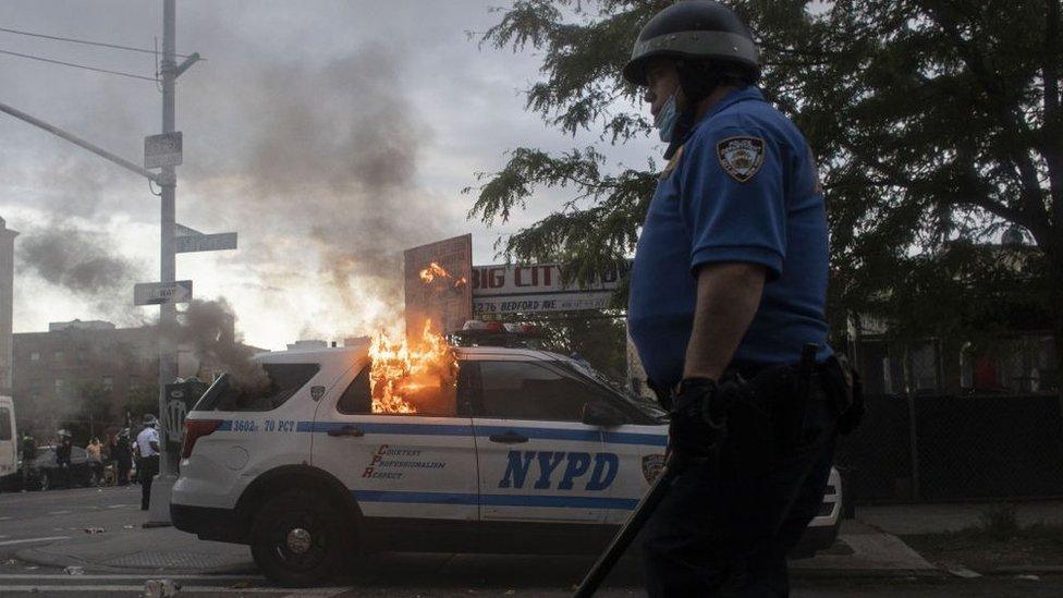 A burning police car in New York