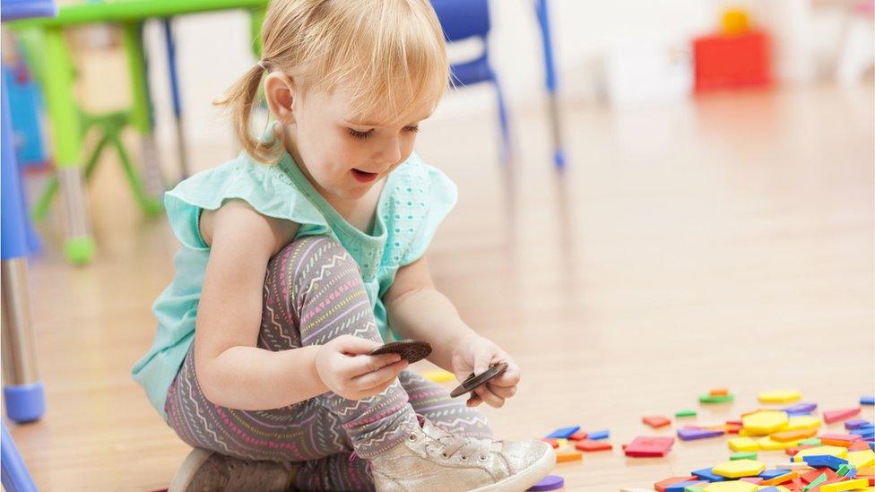 A girl plays with toys