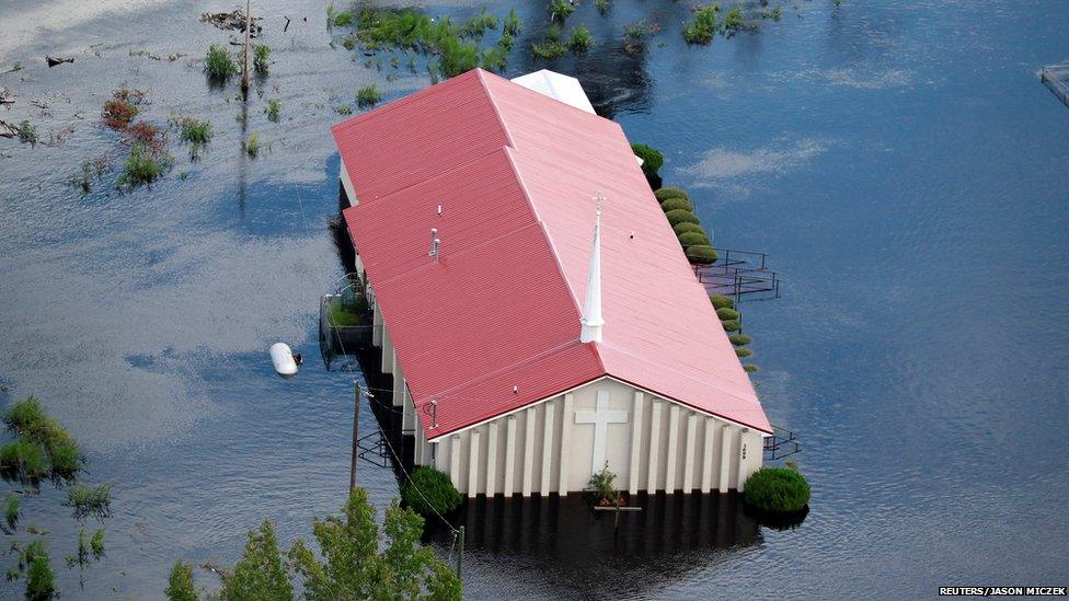 A red roofed church immersed in floodwater