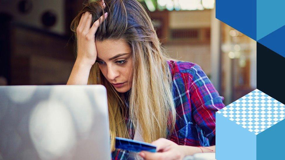 Stressed woman looking at a laptop