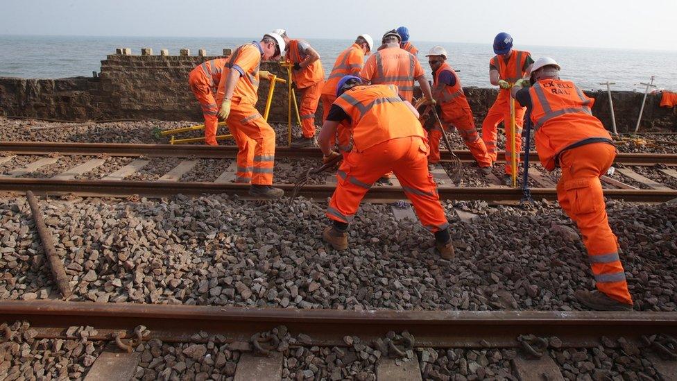 Workers repairing a rail line