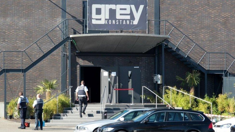 Police officers stand at the door of the night club "Grey" in Konstanz, Germany, on 30 July 2017. According to a police report, a 34-year-old man shot at several people inside the club in the early morning.