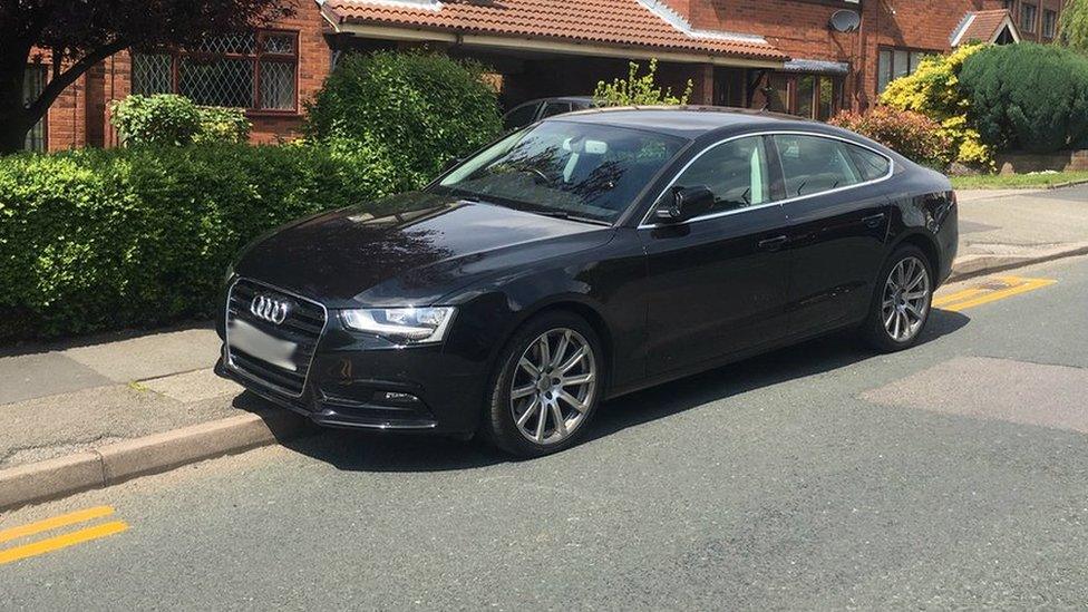 Car parked in gaps in double yellow lines