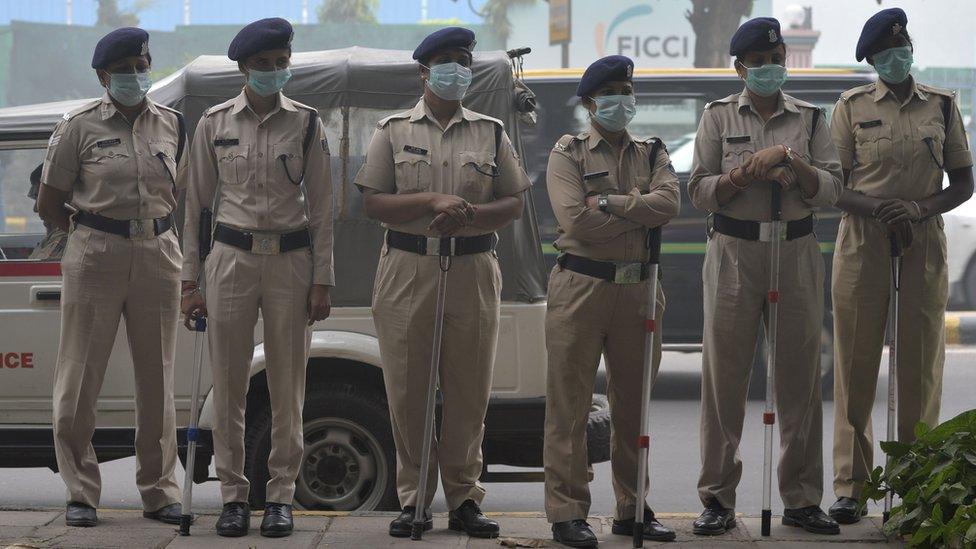 A row of police wearing facemasks to protect themselves from the toxic smog