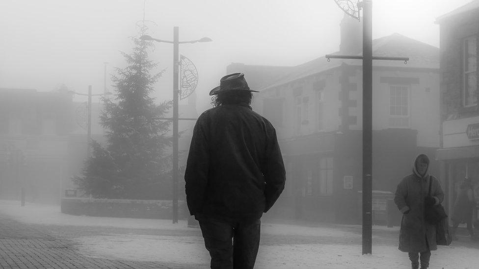 People walking along a misty Middle Street in Consett