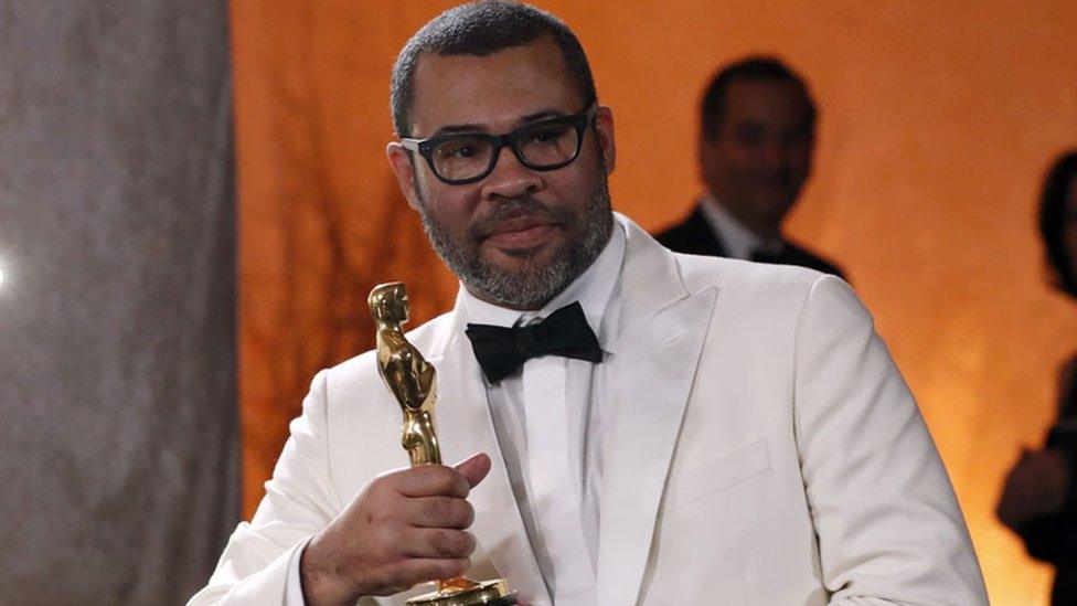 Jordan Peele with his Oscar