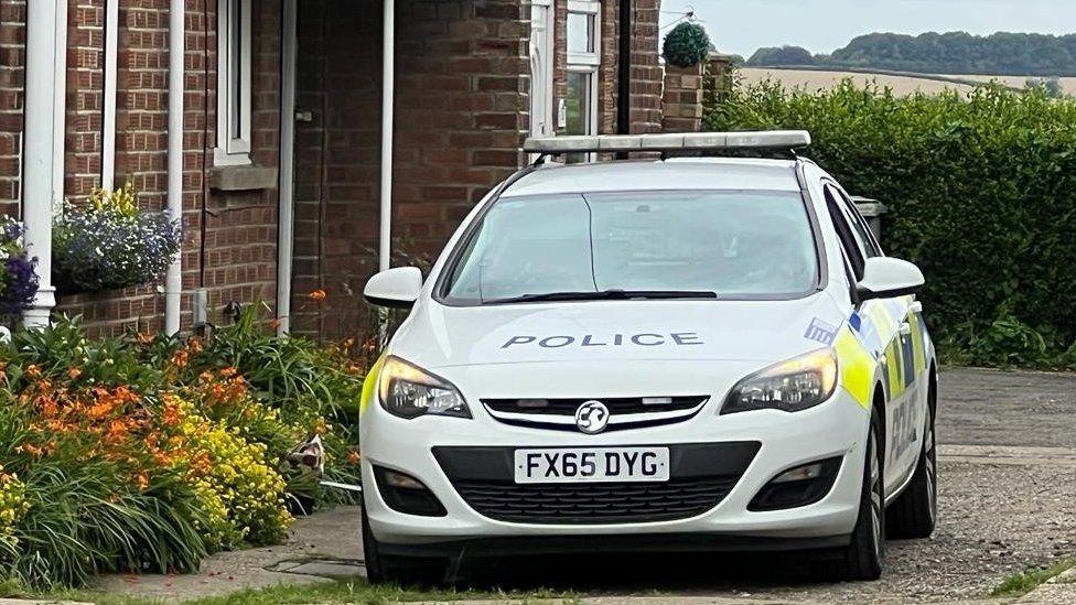 Police car outside a house