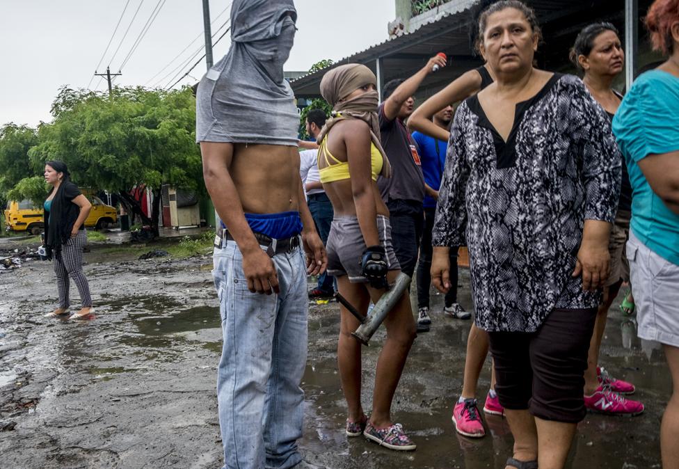 Neighbours and friends gather in front of the house of the Pavón family. Matías, who was only five months old, his two-year-old brother Daryelis, their parents and two more family members died when their house burned down in Managua.