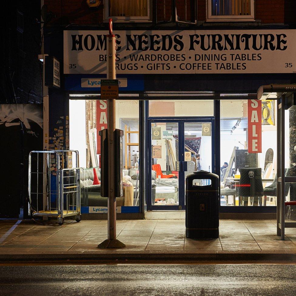 An image of a furniture shop with people inside