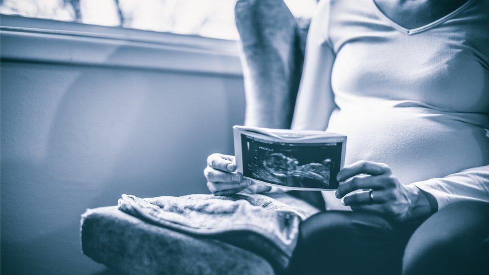 Mother holding ultrasound scan