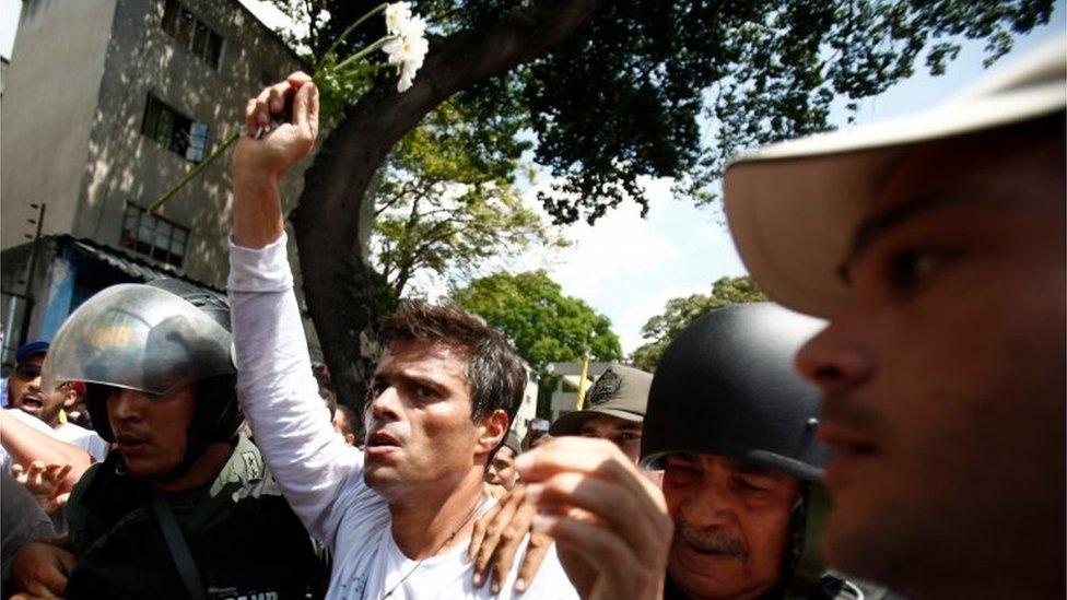 Opposition leader Leopoldo Lopez is flanked by Bolivarian National Guards after Lopez handed himself in to the authorities in Caracas, Venezuela on 18 February, 2014