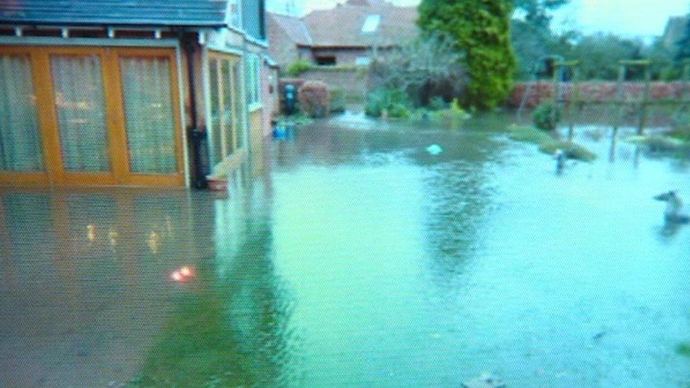 A garden flooded after a burst water pipe in Nottinghamshire