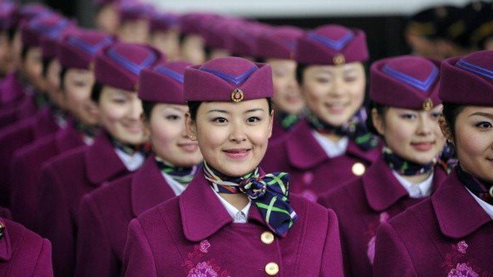 A group of attendants prepare to board a newly-launched bullet train bound for Beijing