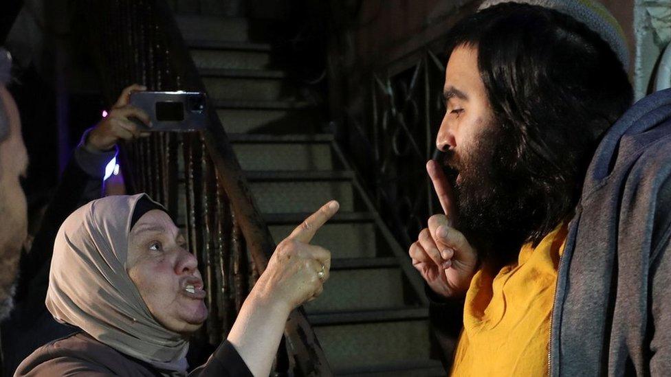 A Palestinian woman and an Israeli man argue ahead of an Israeli Supreme Court hearing about the case of Palestinian families facing eviction from their homes in the Sheikh Jarrah of occupied East Jerusalem (3 May 2021)