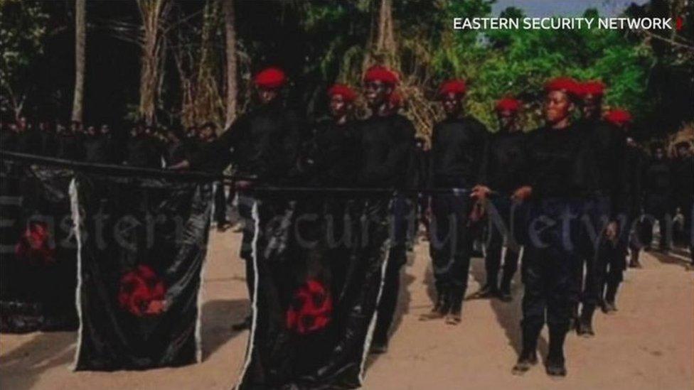 Men in black clothes and red berets