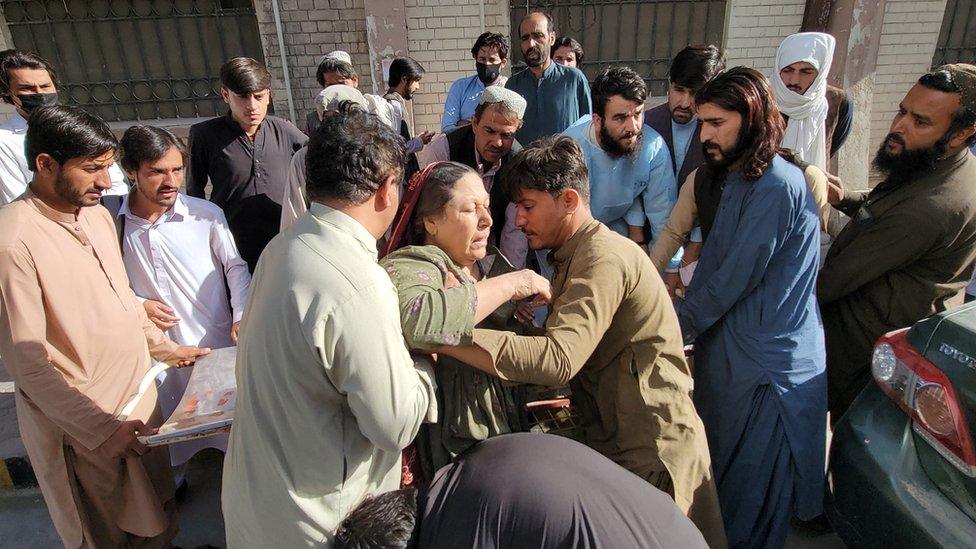 People shift an injured victim, after a 5.9 magnitude earthquake with a shallow depth of nine kilometres struck Harnai, to a hospital in Quetta, Balochistan province, Pakistan, 7 October 2021