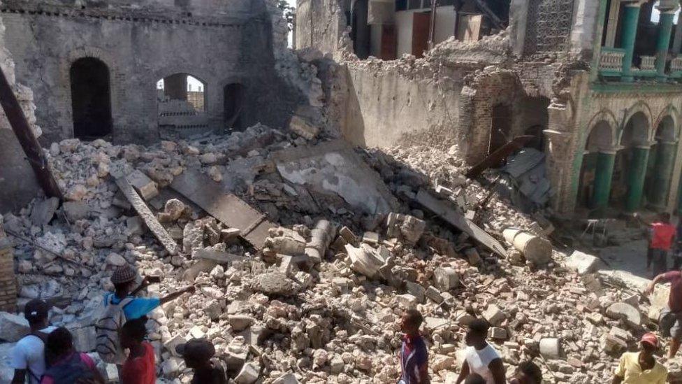 Damaged buildings as people inspect after a 7.2 magnitude earthquake