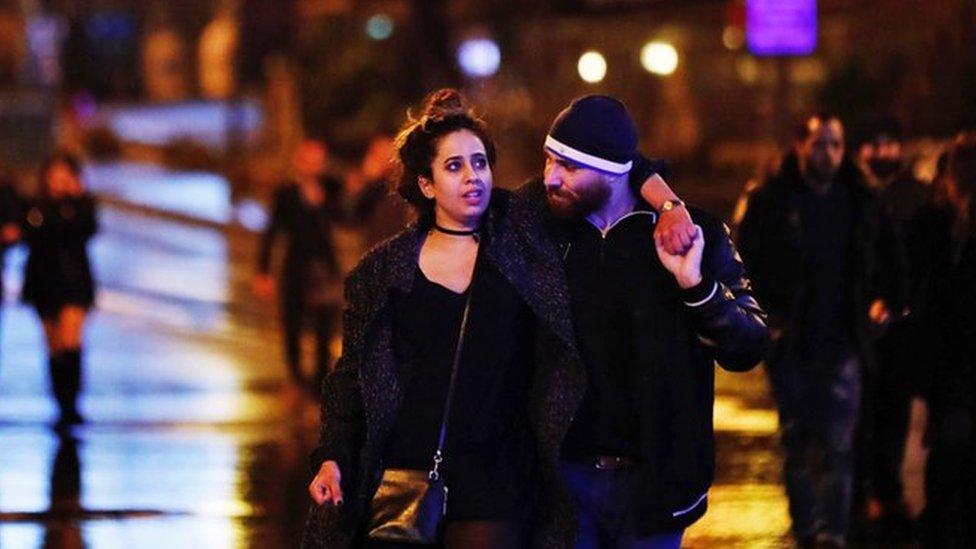 Young people leave from the scene of an attack in Istanbul, early Sunday, Jan. 1, 2017