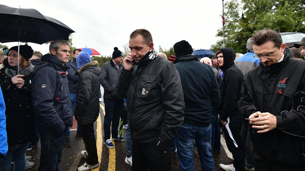 george Brash of the Unite trade union talks on his phone outside the Wrightbus factory