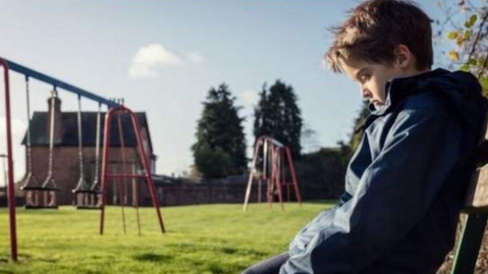 A child on a park bench