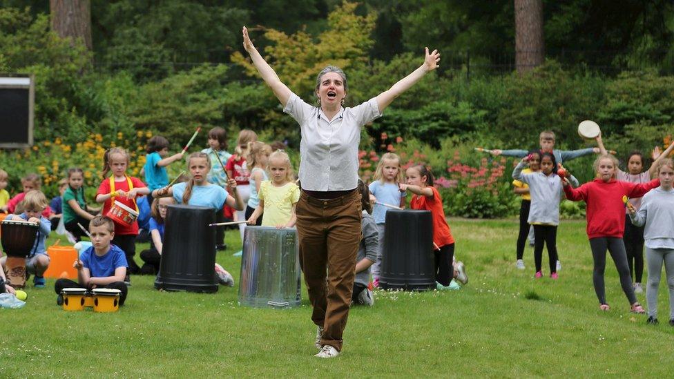 Grace Surman with children drumming at Quarry Bank Mill