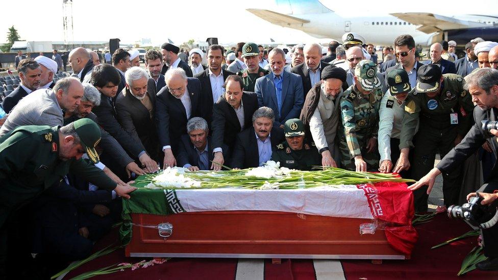 Iranian officials touch the coffin of a Hajj pilgrim killed in a stampede in Mecca (3 October 2015)