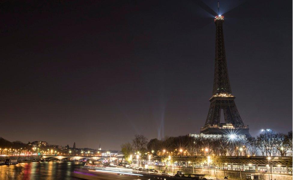 The Eiffel Tower stands dark, as its traditional night-time illumination is switched off in support of the victims of the Aleppo siege in Syria, in Paris, France,