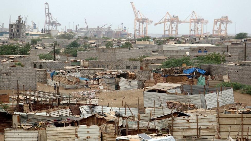 Cranes at Hudaydah's port are pictured near a shantytown (16 June 2018)