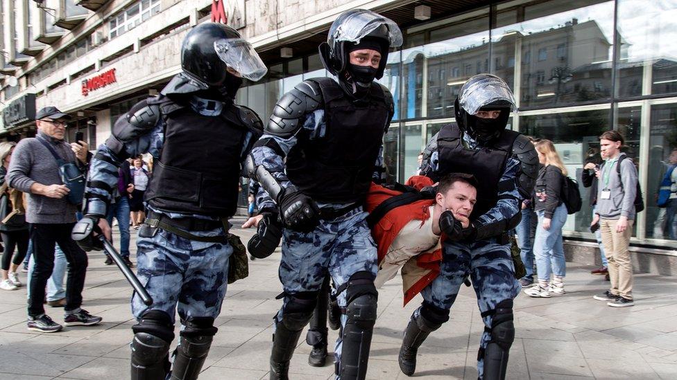 Police officers detain a man during an unsanctioned rally in the centre of Moscow, Russia, 3 August 2019