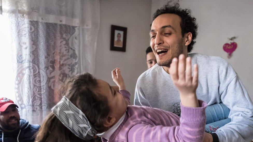 Egyptian photojournalist Mahmoud Abou Zeid, widely known as Shawkan, plays with his niece at his home in Cairo on 4 March 2019