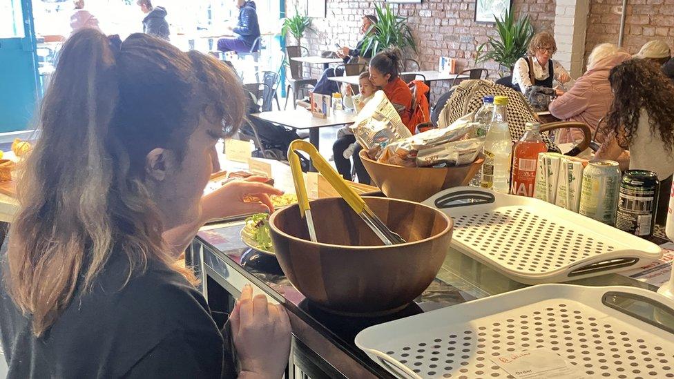 A photo of a trainee working at the café