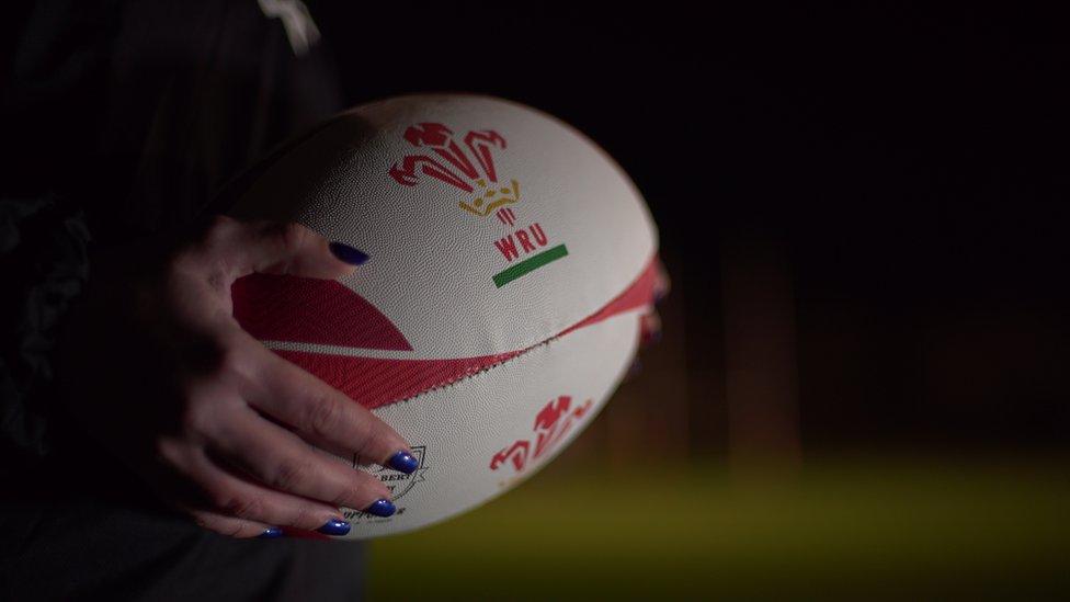 A player holding a rugby ball