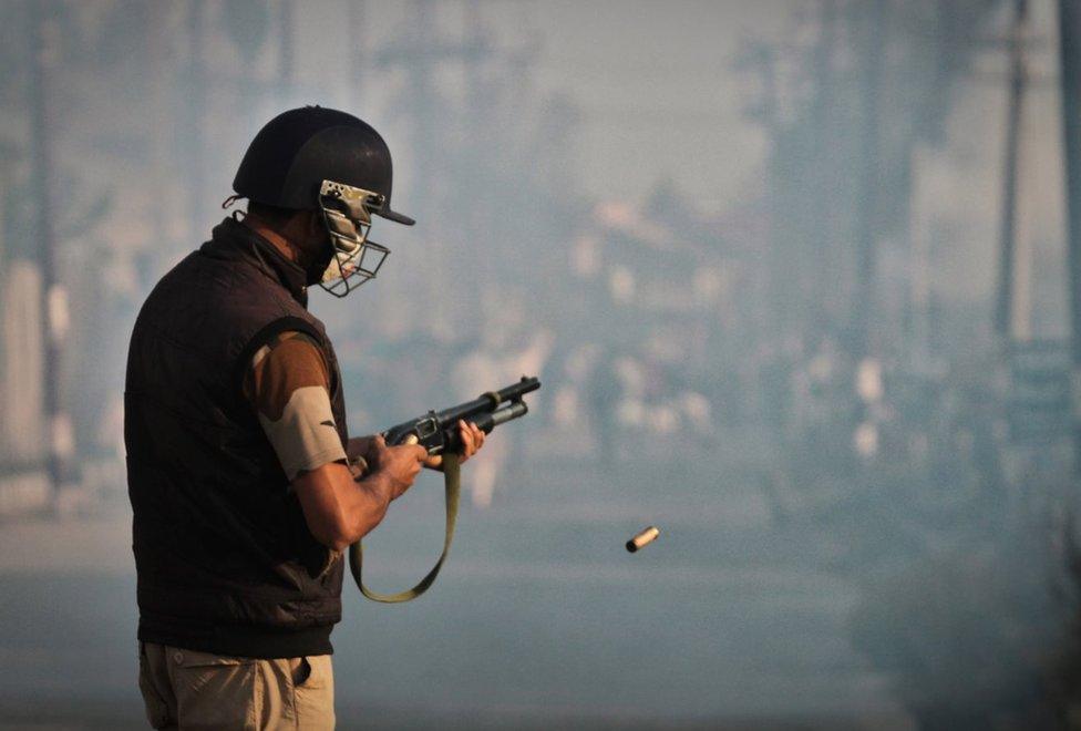 A soldier firing a pellet gun