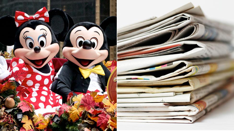 Mickey and Minnie Mouse and some newspapers