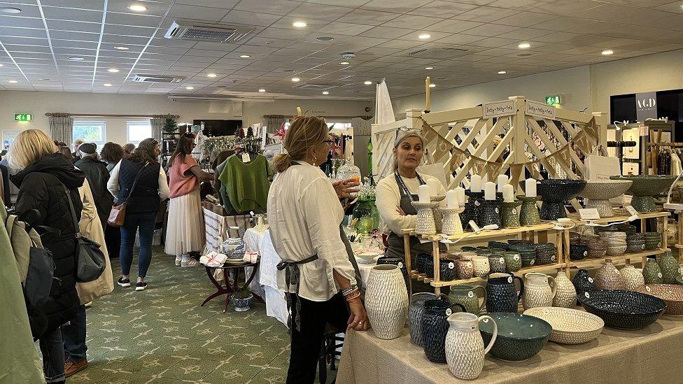 A room with stalls and customers