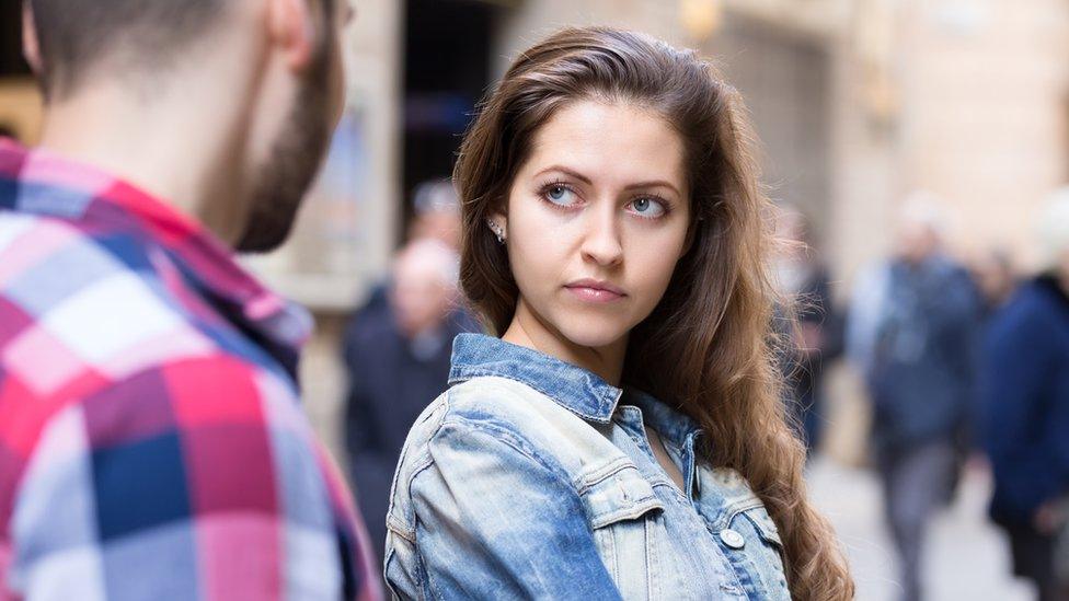Woman looking at a man