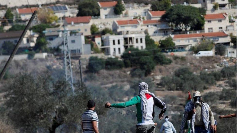 Palestinians look towards a Jewish settlement in the occupied West Bank (file photo)