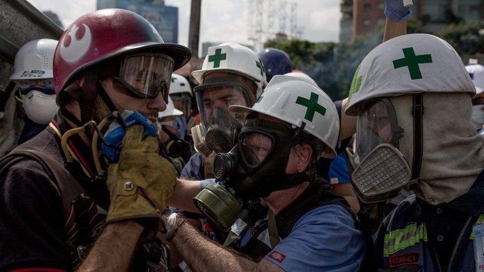 Volunteers - in white helmets with a green cross - have been treating the injured