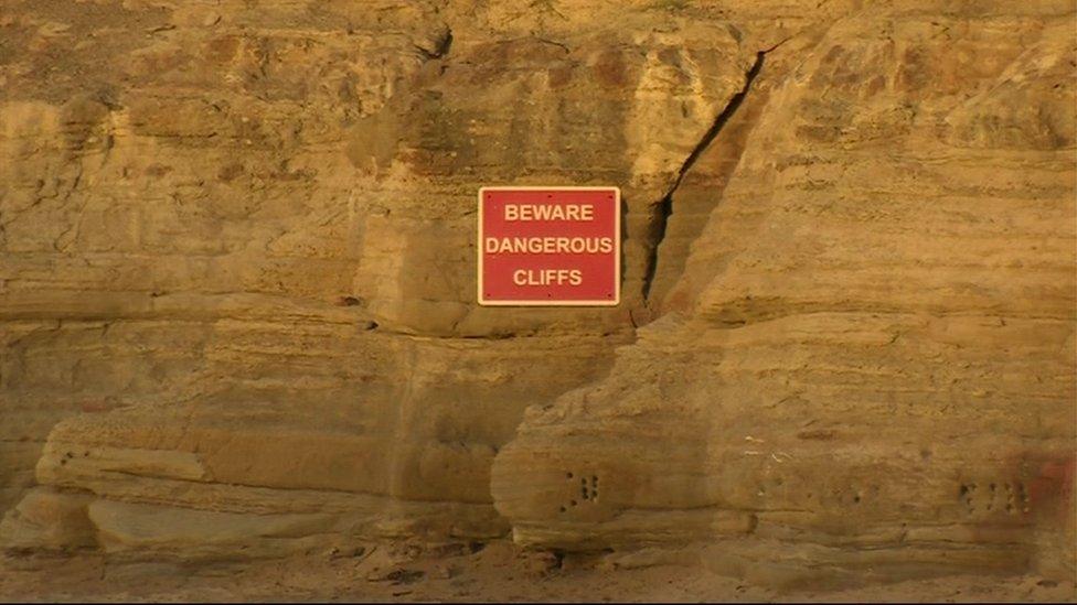 Warning sign on cliffs