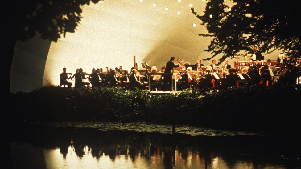 An orchestra gives a concert of classical music in the grounds of Kenwood House, London, circa 1975