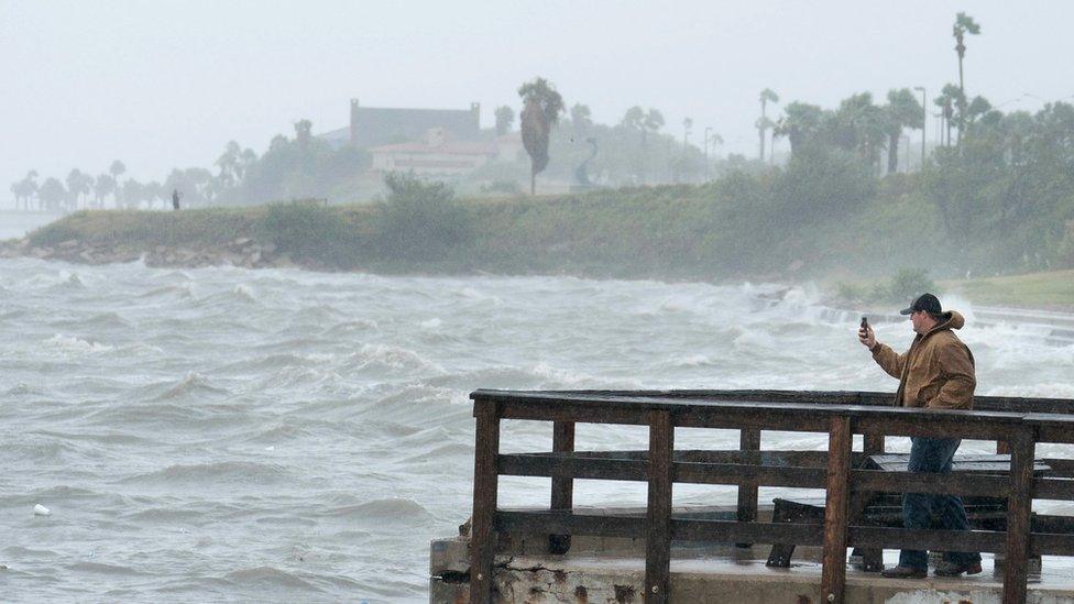 Local resident Josh Anderson shoots video of the storm on his mobile device at Cole Park as Hurricane Harvey approaches in Corpus Christi, Texas, USA, 25 August 2017