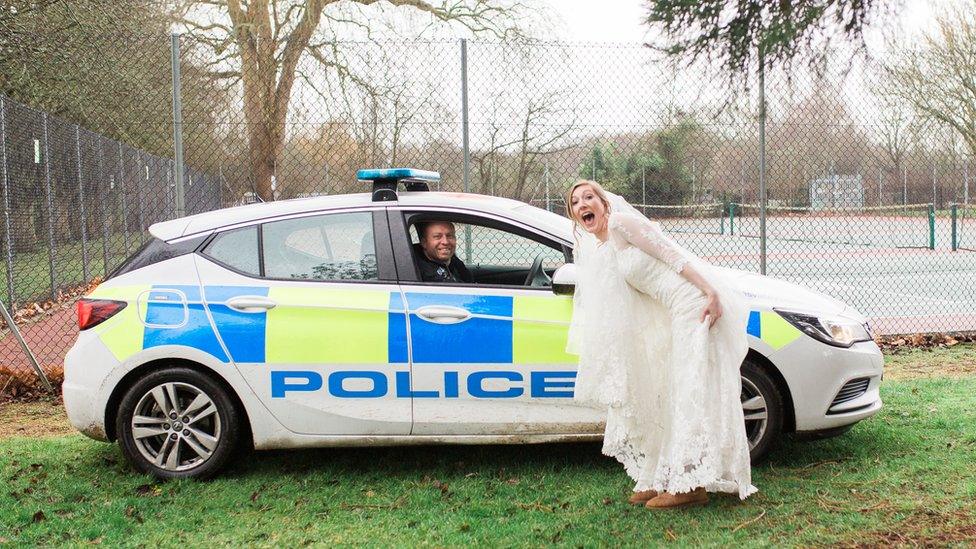 Becky Eyre in front of police car